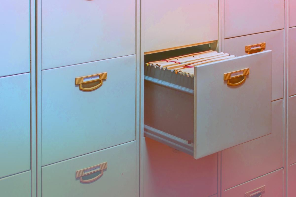 Filing cabinet with a slightly open drawer full of files
