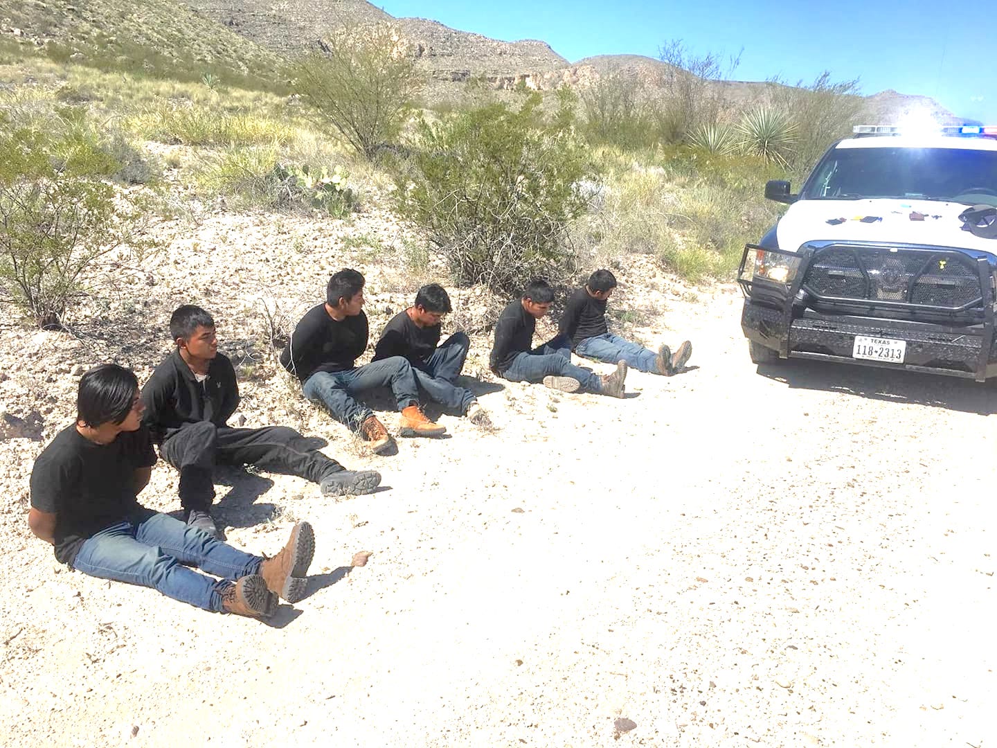 Migrants pulled over on side of road.