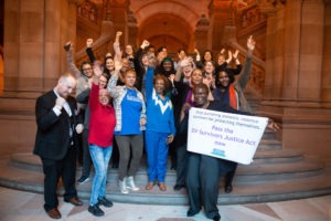 New York State Senator Roxanne J. Persaud with supporters of the Domestic Violence Survivor's Justice Act