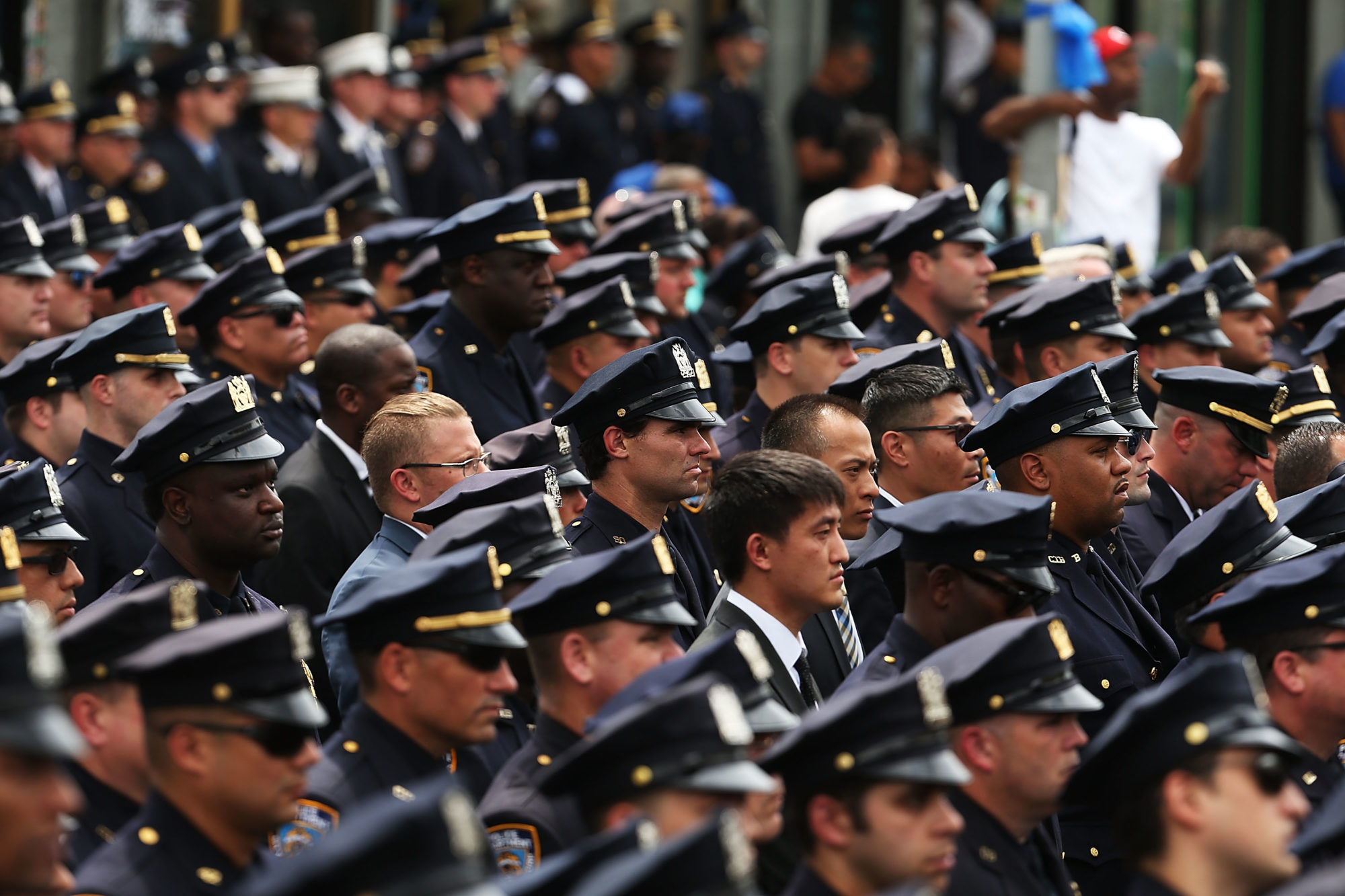 Thousands of police officers and their supporters stand outside