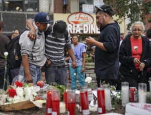 Mourners visit a makeshift memorial for four homeless men who were murdered in Chinatown over the weekend October 7, 2019 in New York City.