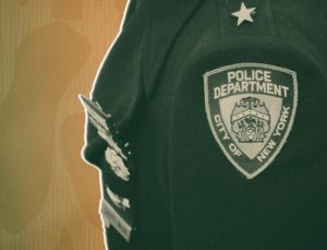 Police uniform with arm badge that says NYPD