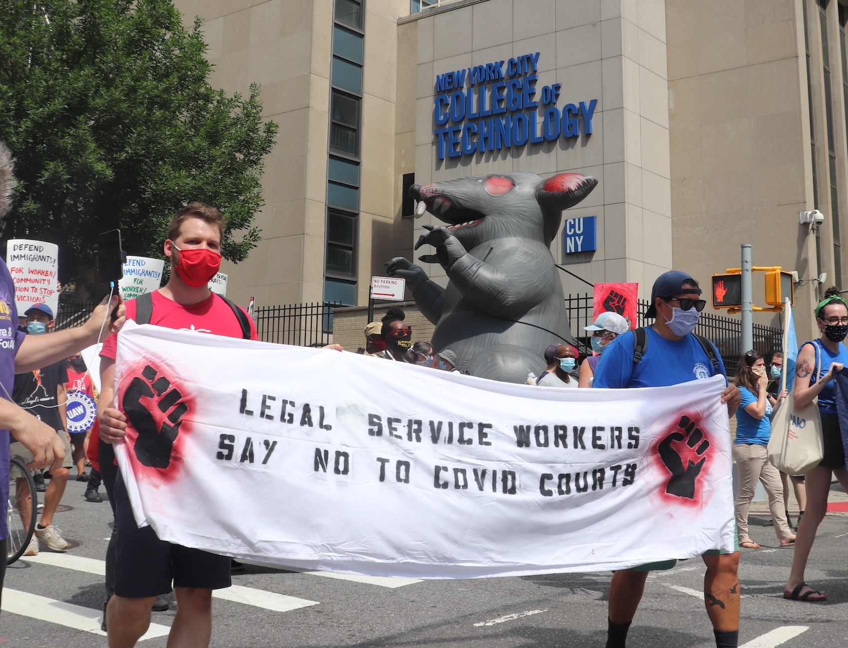 Protesters hold a sign reading