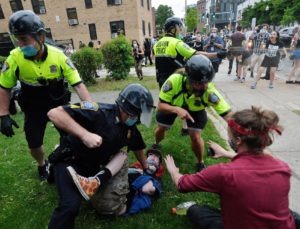 Boston police officer holds protester