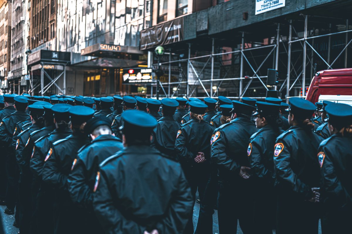 nypd officers stand in procession