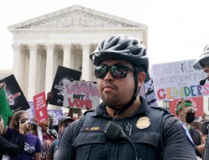 Police and protesters outside of the Supreme Court after Roe was overturned.
