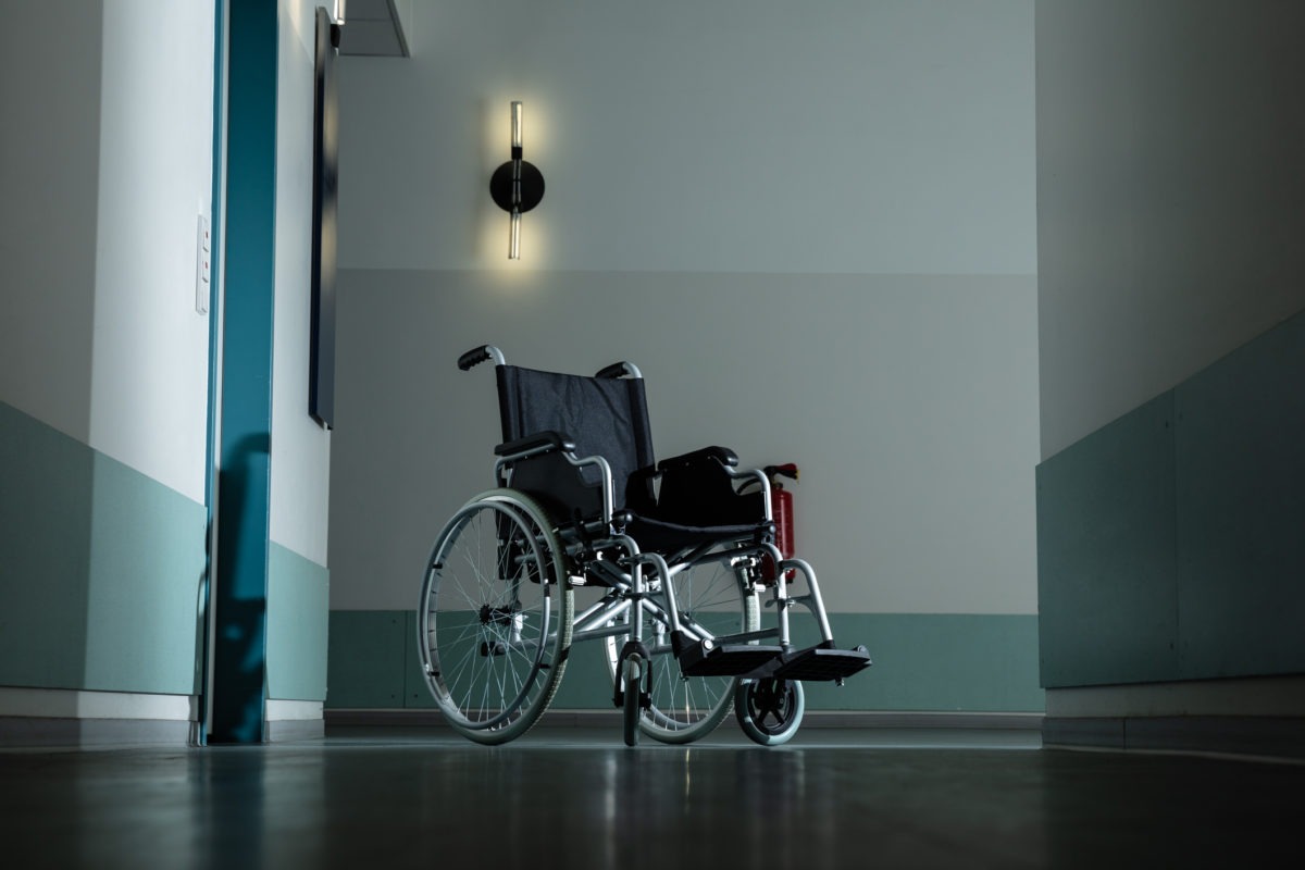 Empty Wheel Chair In Hospital Corridor