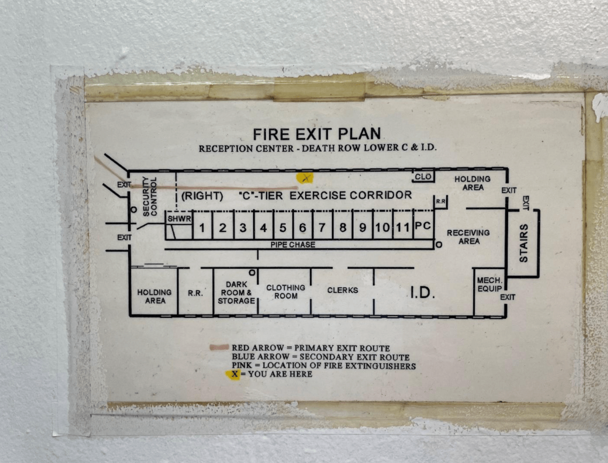 A fire escape plan sign identifying the unit as Angola's old death row.