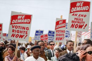 Marchers holding signs demanding voting rights during the March on Washington