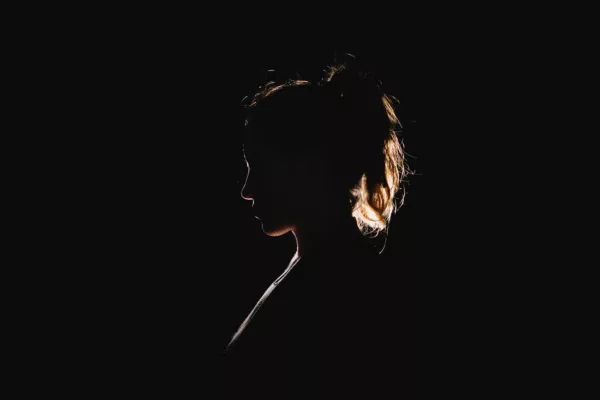 Silhouette of a woman against a black background