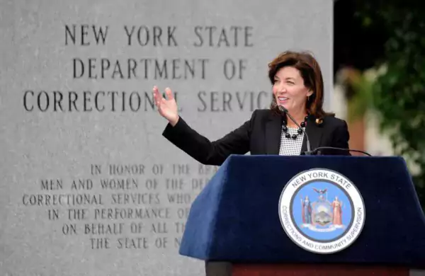 Now-New York Gov. Kathy Hochul stands in front of a memorial to New York State correctional workers.