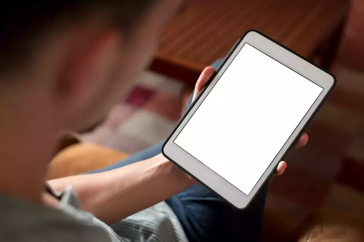 a man looks at a blank digital tablet