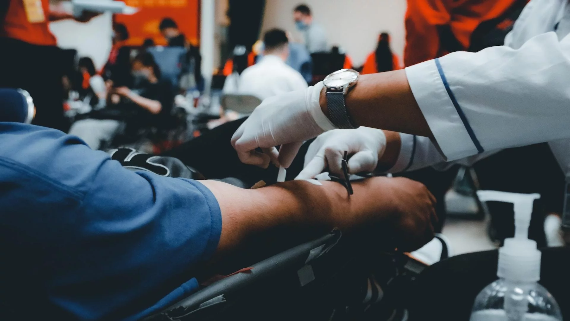 This photo shows a close-up of a doctor using a cuff to take a person's blood-pressure.