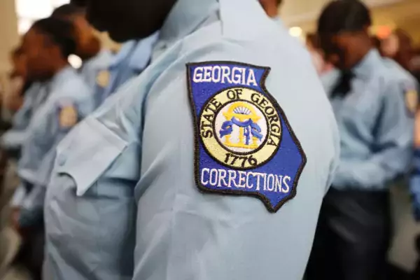 This photo shows a close-up of a Georgia DOC uniform patch in the shape of the state.