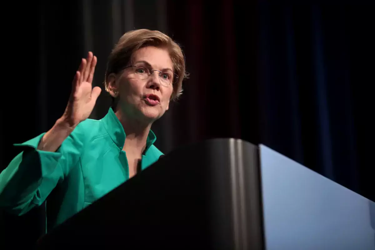 Sen. Elizabeth Warren stands at a lectern giving a speech.
