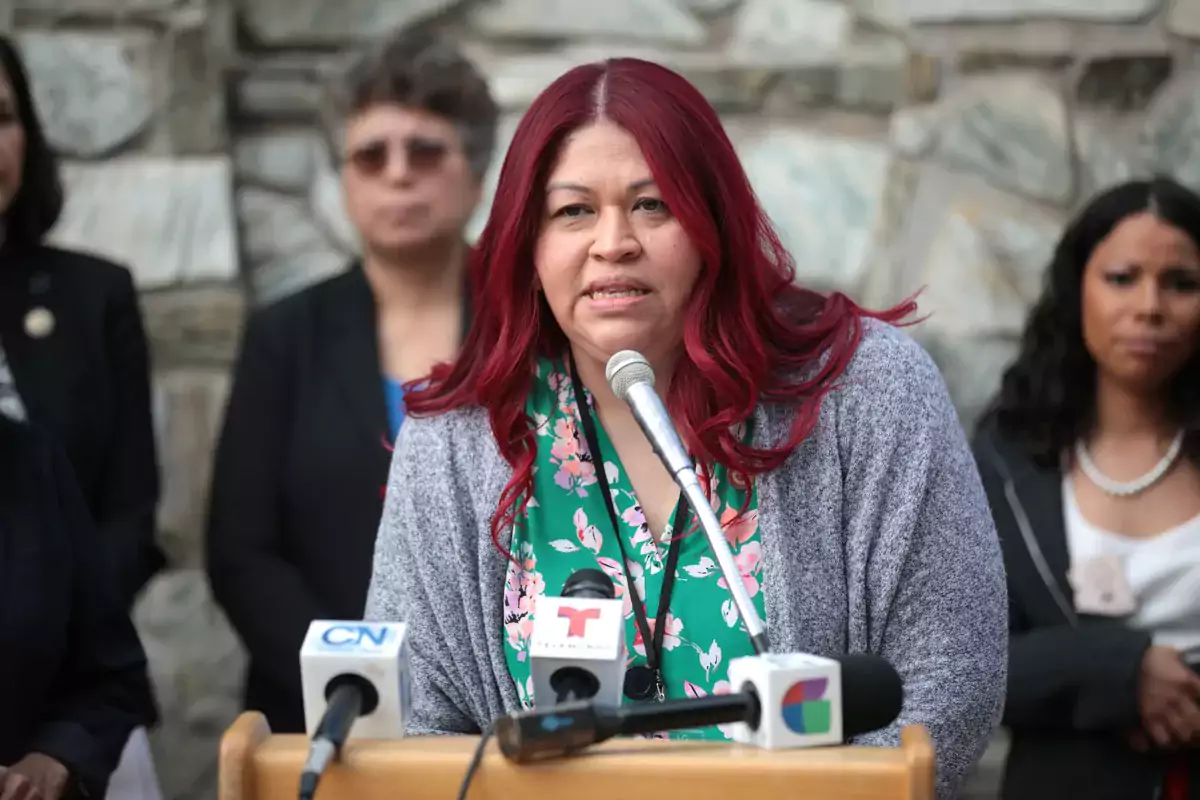This photo shows Arizona State Sen. Anna Hernandez speaking at a lectern outdoors. Hernandez filed a bill to repeal felony murder in Arizona.