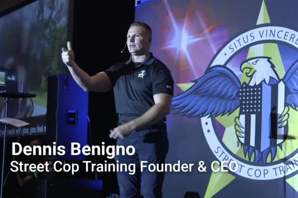This photo shows Street Cop CEO Dennis Benigo standing onstage.