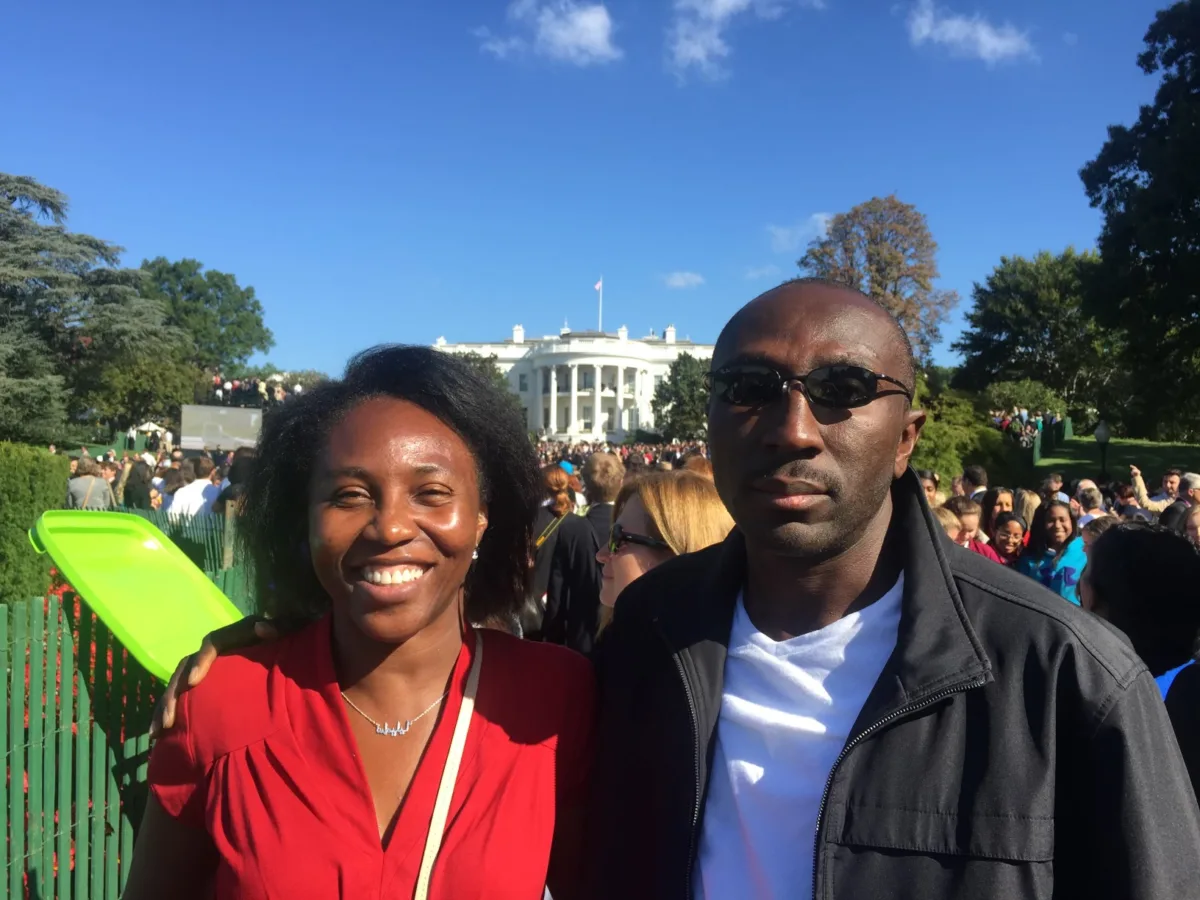 Photo of two people outside, woman in red—Samuel and Samilia at the White House for Pope Francis's visit to the U.S.