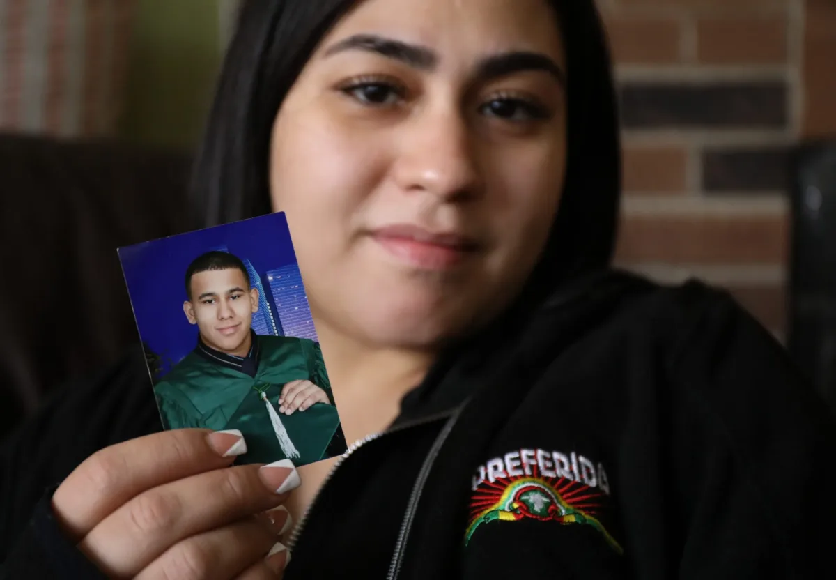 Daniel Colon’s sister, Jamie Colon, holds a middle-school graduation photo of her brother.