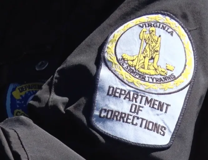 This photo shows a close-up of the patch on a Virginia Department of Corrections officer's uniform sleeve.