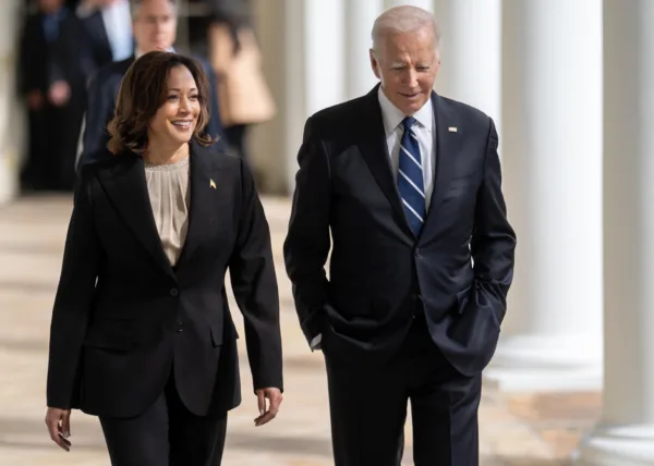 This photo shows President Joe Biden and Vice President Kamala Harris walking outdoors together on the White House grounds.