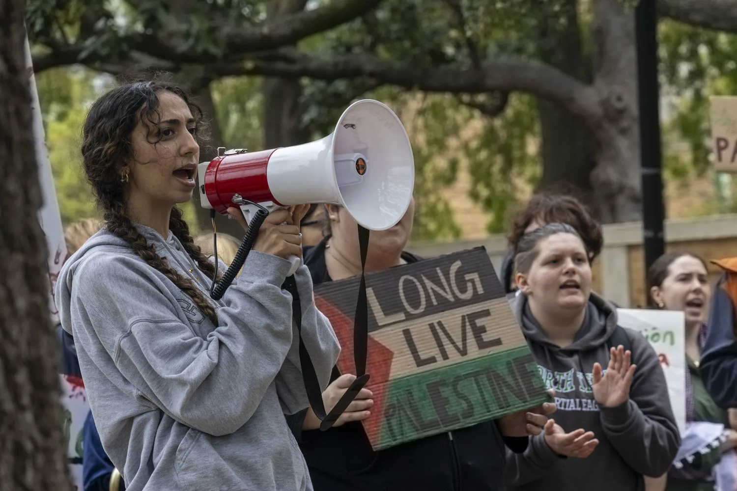 This photo shows a woman shouting into a bullhorn at a pro-Palestine protest.