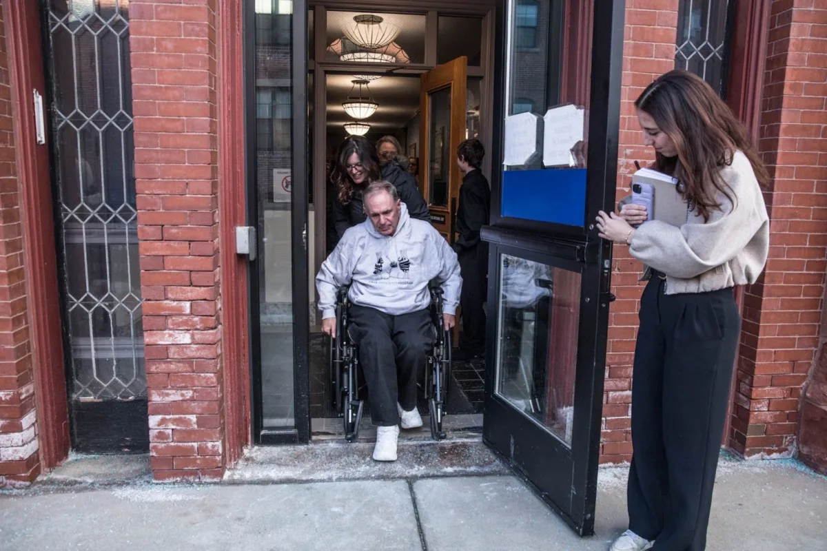 James Carver is wheeled out of the Superior Court building in Lawrence by his daughter, Kaitlyn Verzi.