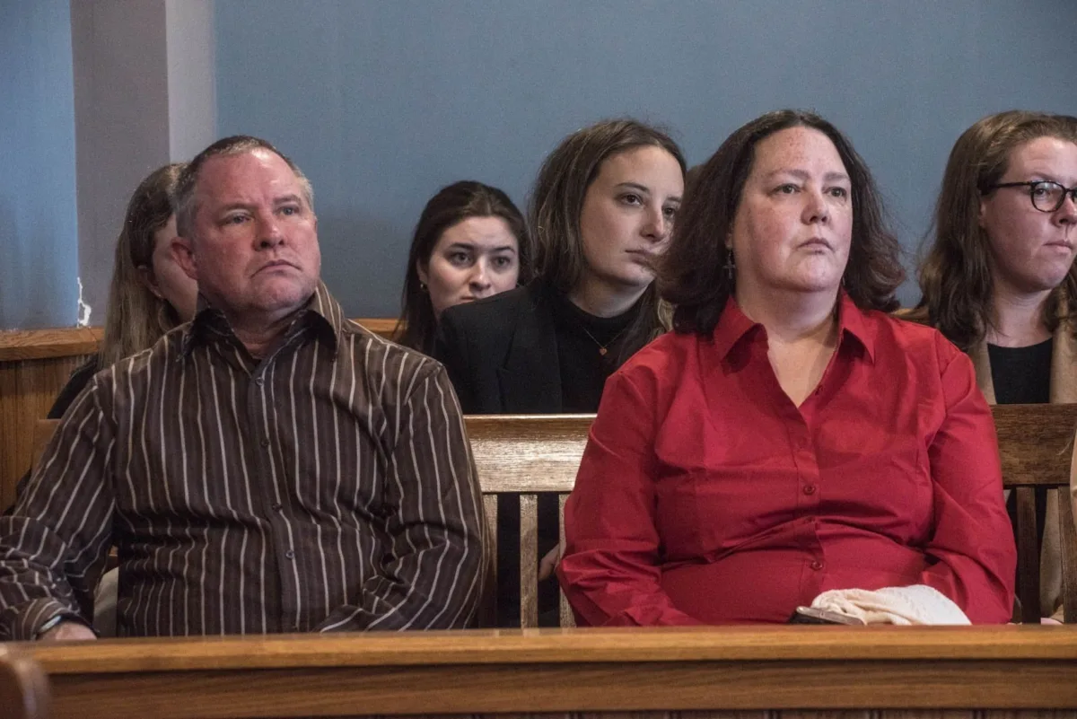 Tracie Lee Dalton and her husband appear in court for James Carver’s bail hearing. Dalton’s older brother, George Flynn, was one of 15 people killed by the 1984 Elliott Chambers Rooming House fire in Beverly.