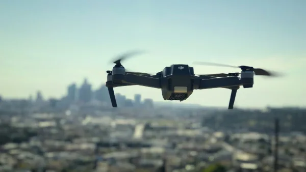 A drone hovers above a cityscape