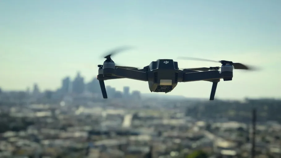 A drone hovers above a cityscape