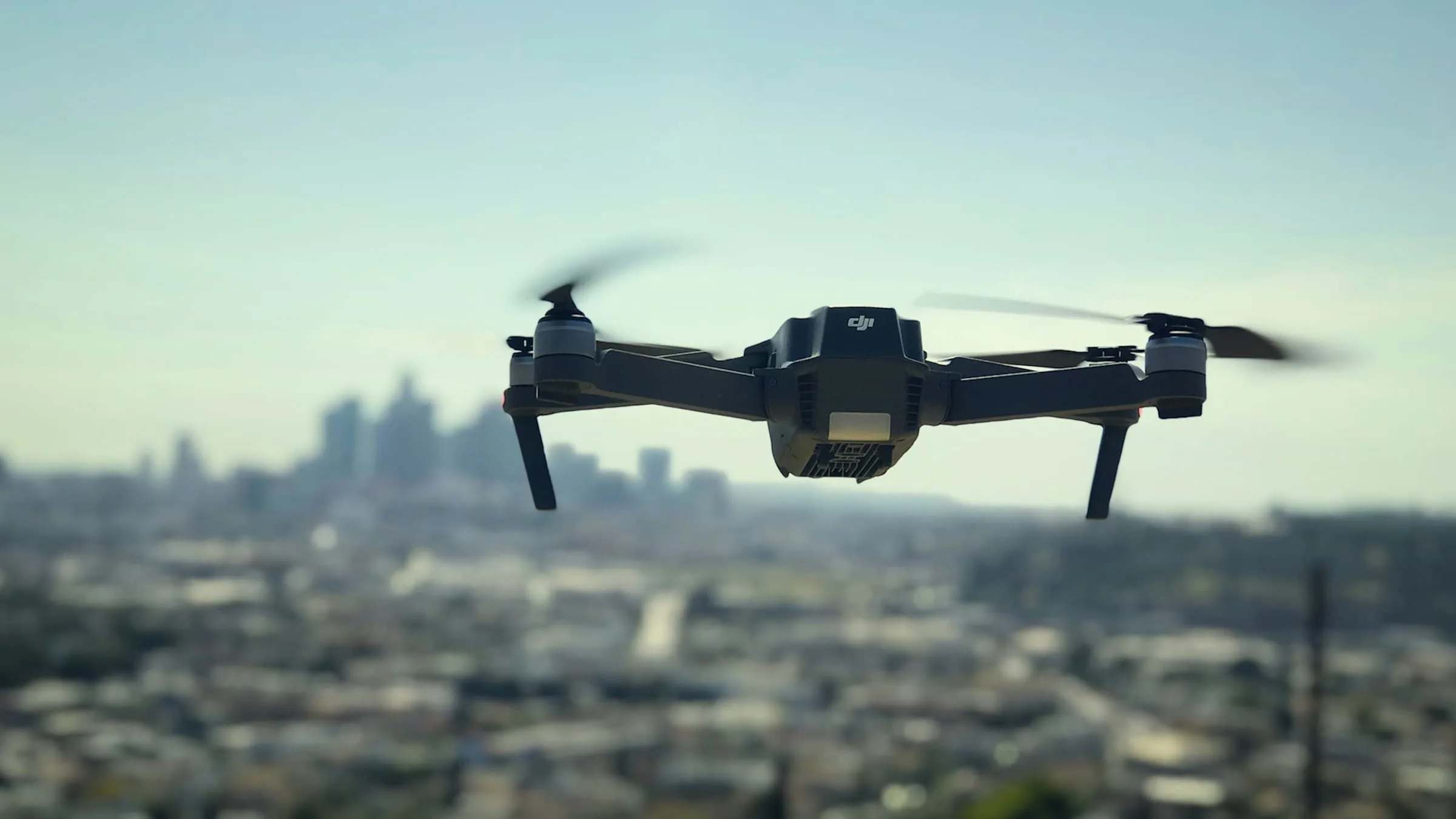 A drone hovers above a cityscape